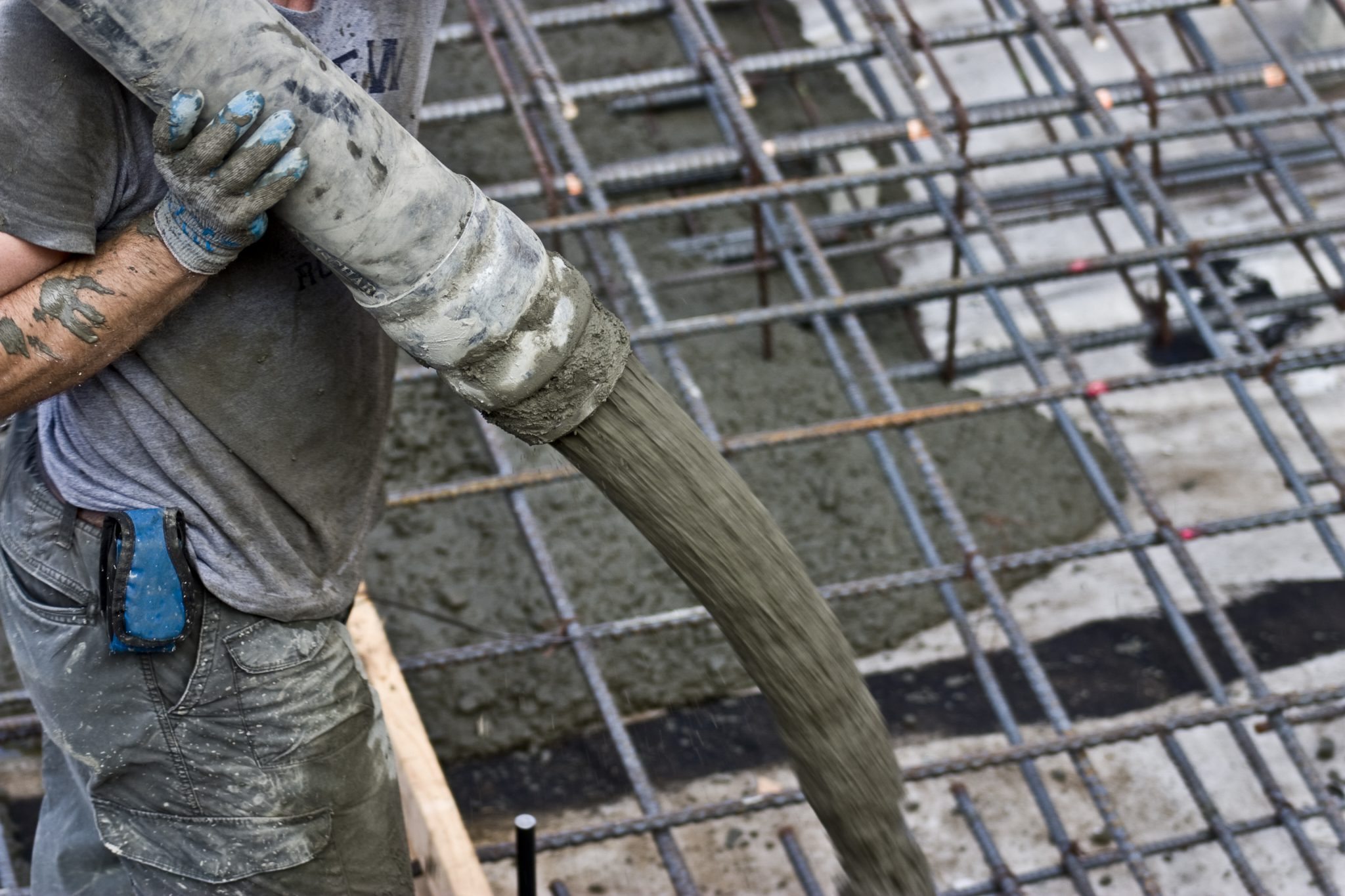 Stock Image - Workers pumping concrete